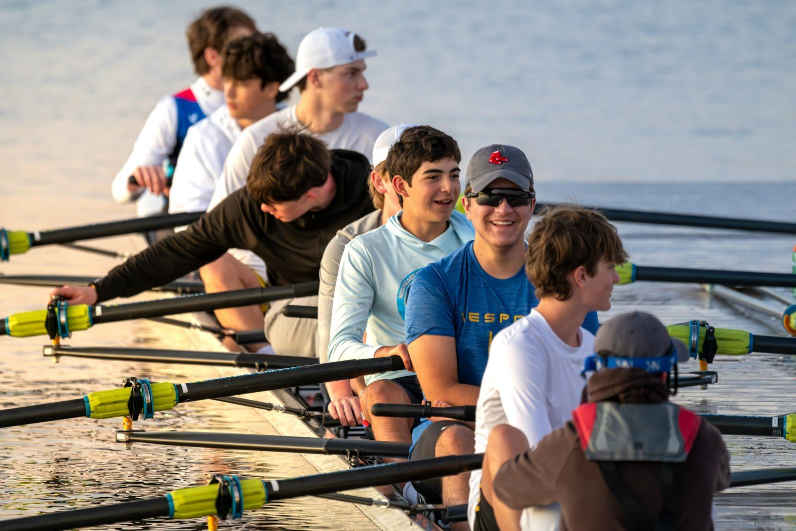 Rowing crew working in sync on calm water